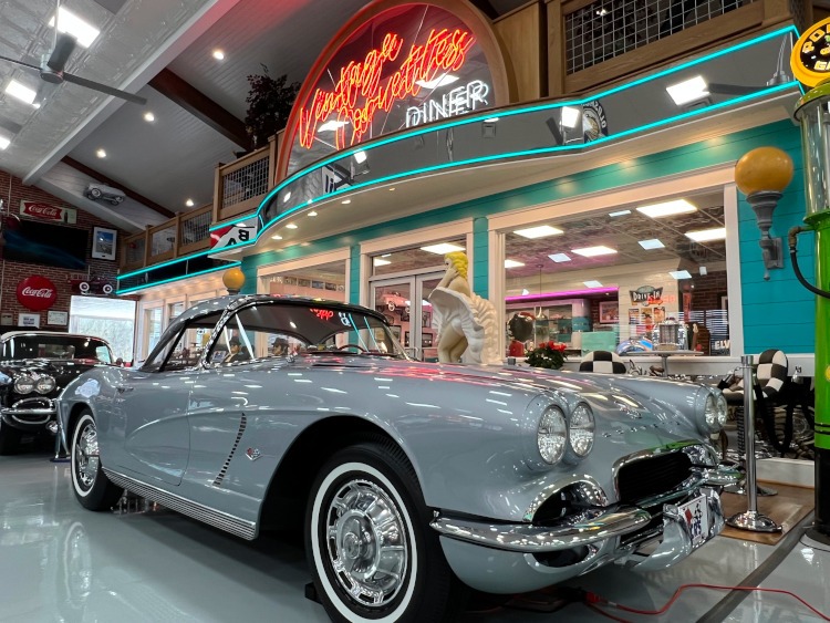 First-generation Corvette outside a retro diner in a museum.