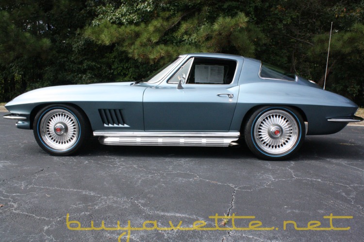 A blue second-generation Corvette with side pipes.