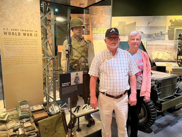 Standing beside a World War II exhibit