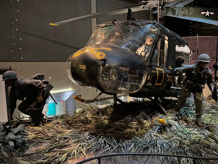 Static display of a helicopter and crew during Vietnam conflict.
