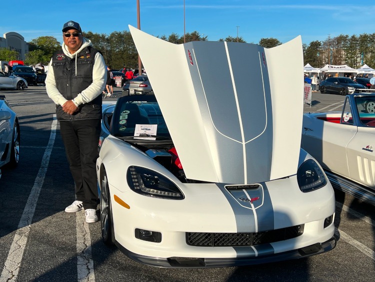 A man standing beside his 2013 60th anniversary Corvette