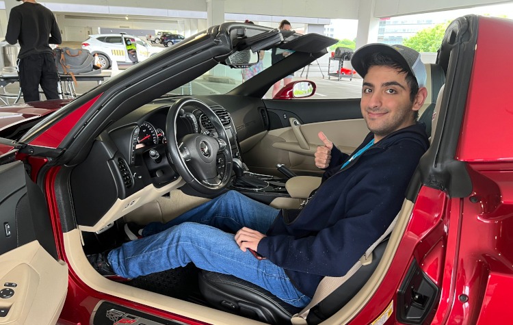 SCAD student sitting in a C6 Corvette