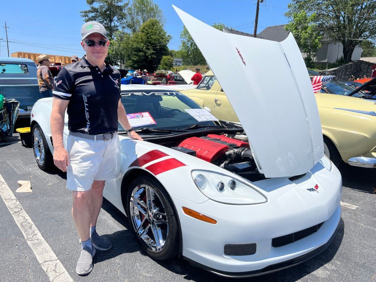 A man stands beside his 2007 C6 Z06 Arctic White Corvette coupe.