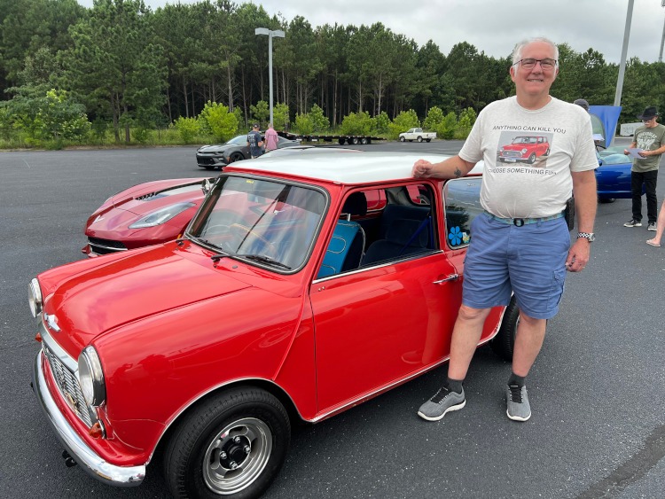 A red 1975 Mini Cooper car with a white top.
