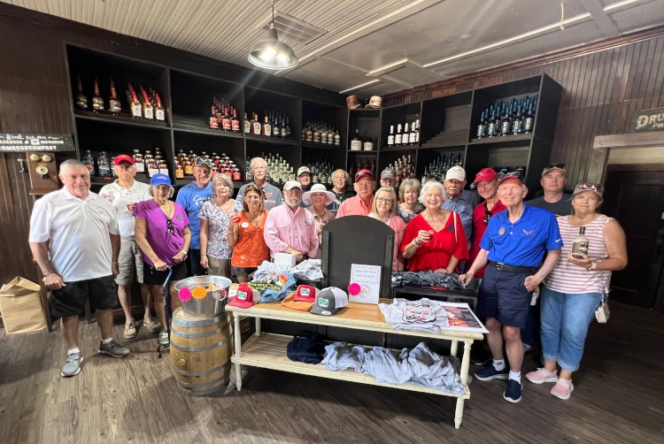 A group photo of Corvette enthusiasts at the RM Rose Distillery.