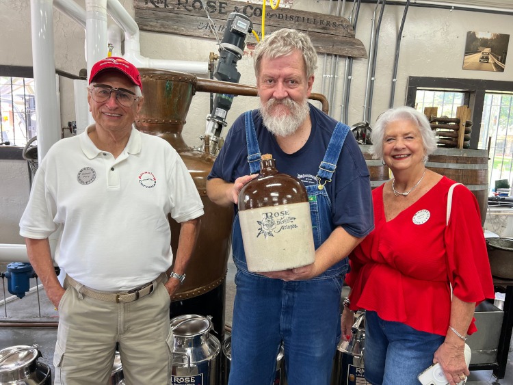 People are standing beside a distillery in Georgia.