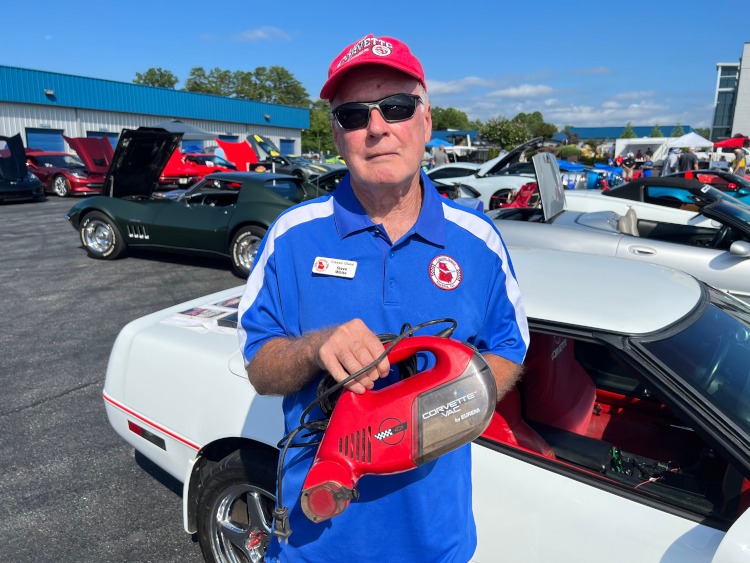 A man holding a Corvette Vac vacuum cleaner