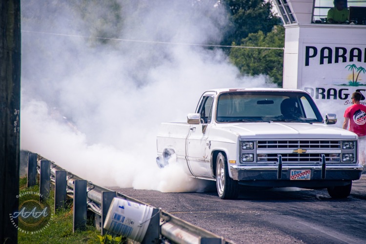 A pickup truck does a smokey burnout.