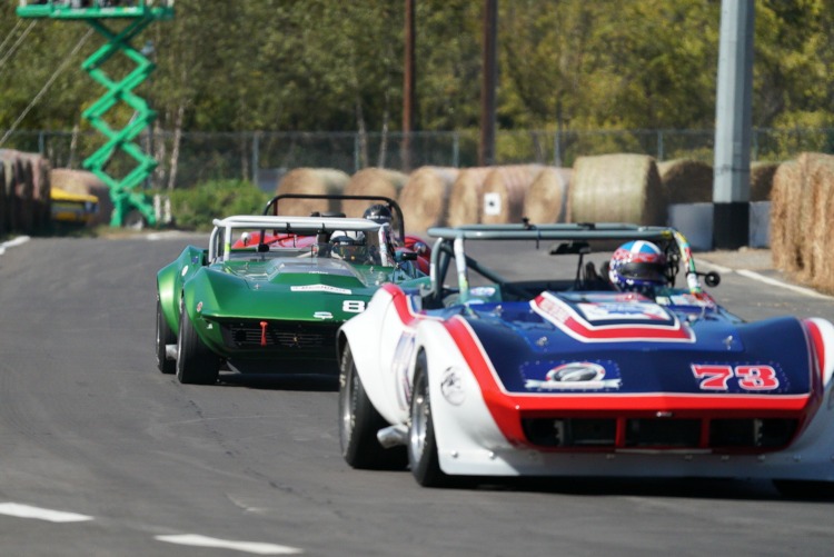 Classic Corvette racecars on a road course.