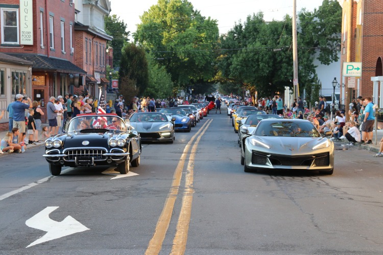 Corvette driving down main street at Carlisle.