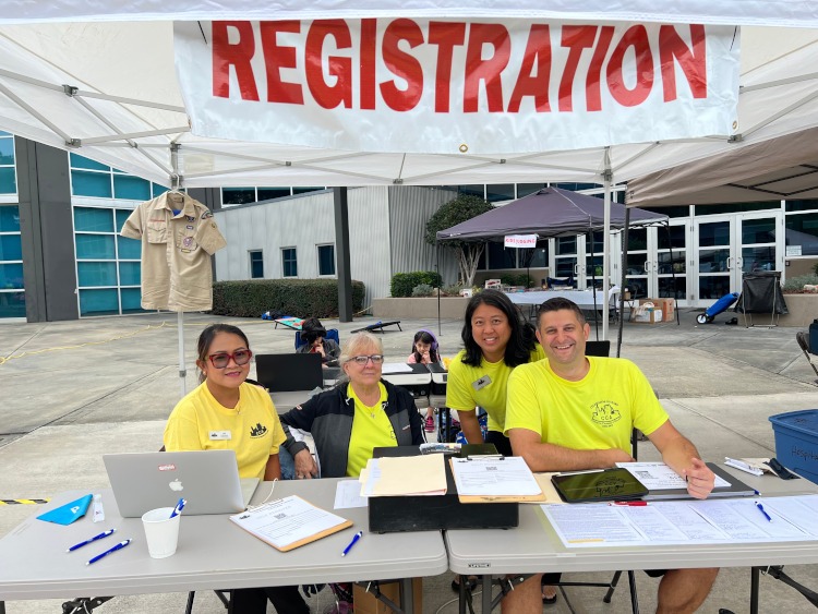 People manning a registration table.