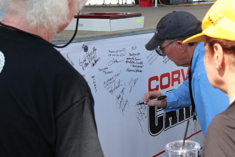 Corvette enthusiasts signing a Reeves Callaway banner.