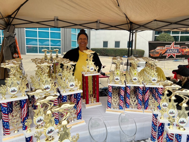 A collection of trophies for a car show.