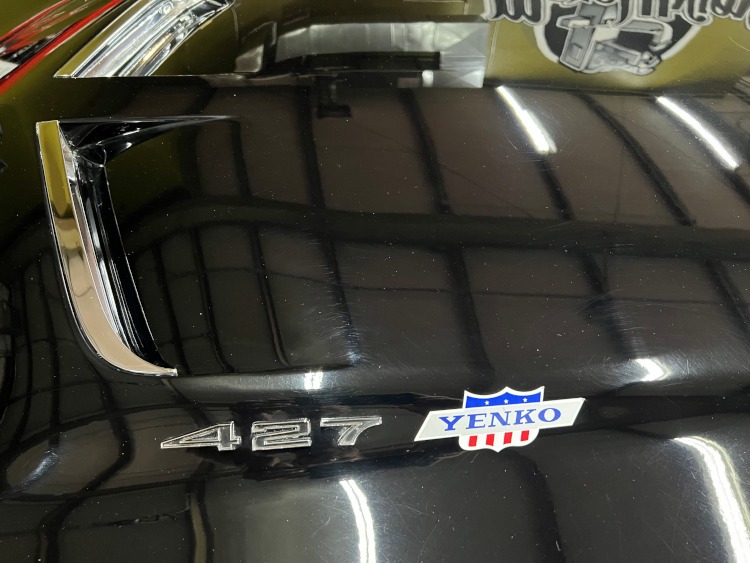 Yenko badges on the black hood of a classic Corvette.