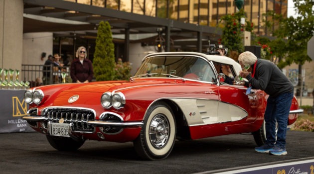 A red Corvette convertible getting a trophy.