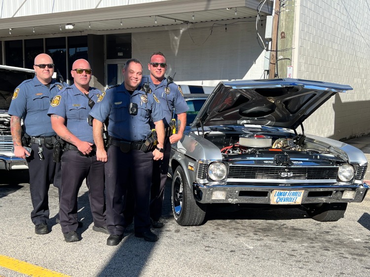 Members of the Loganville Police Department at a car show. .