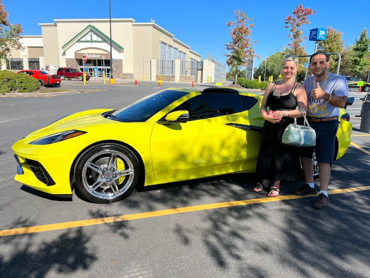 A yellow eighth-generation Corvette in a parking lot.