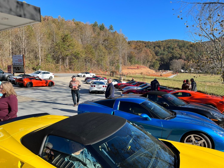 20 Corvettes parked at a country gas station.