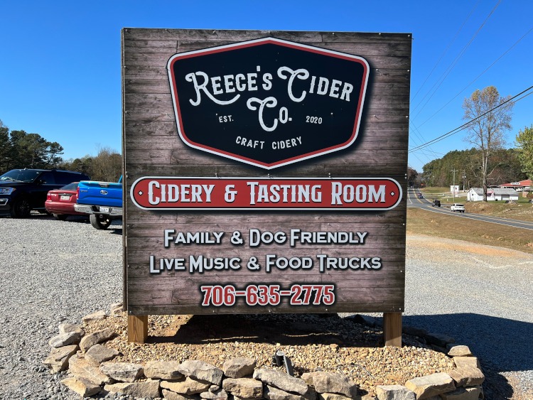 A sign near the road advertising Reece's Cider company