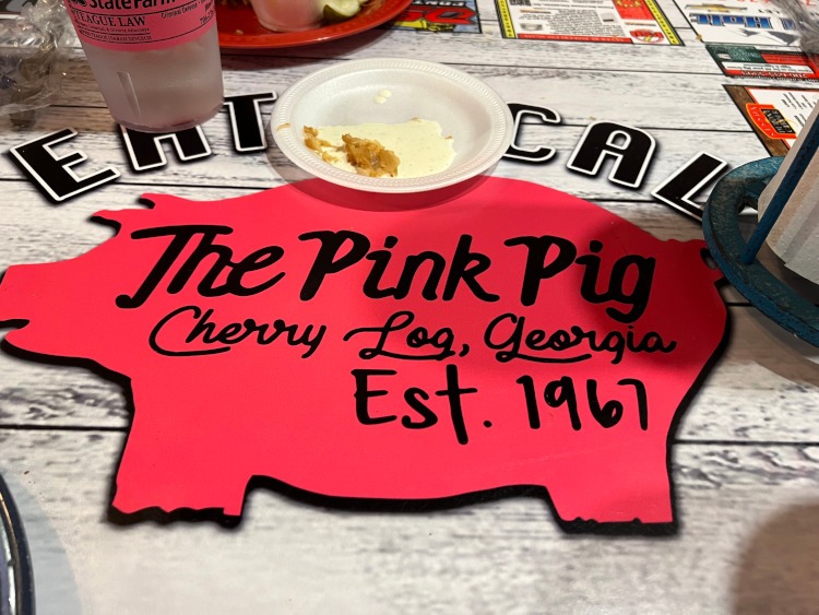 The Pink Pig restaurant logo in the table.