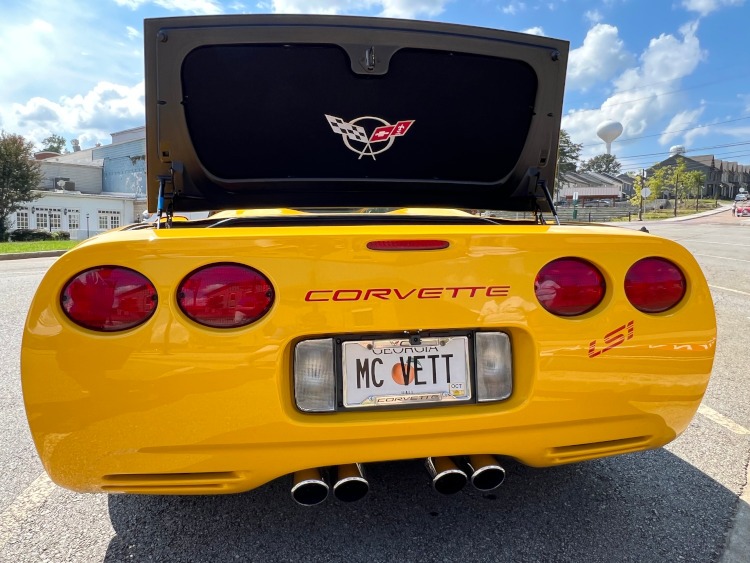 The tail end of a fifth-generation Corvette with raised trunk lid.