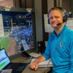 A man is broadcasting a baseball game.