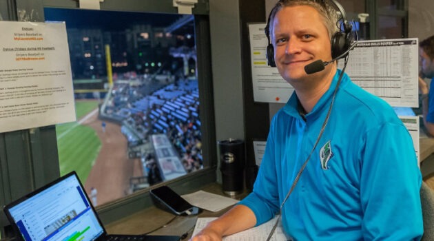 A man is broadcasting a baseball game.