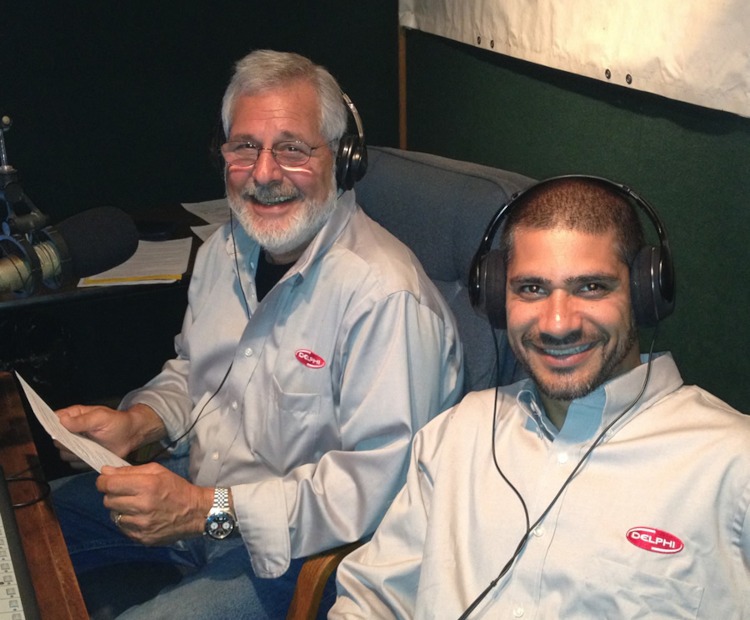Two men in a radio booth with headphones.