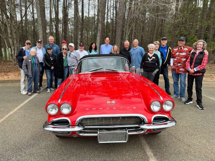 A group of people around a 1962 Corvette. Photo taken by Vettes of Atlanta Magazine.